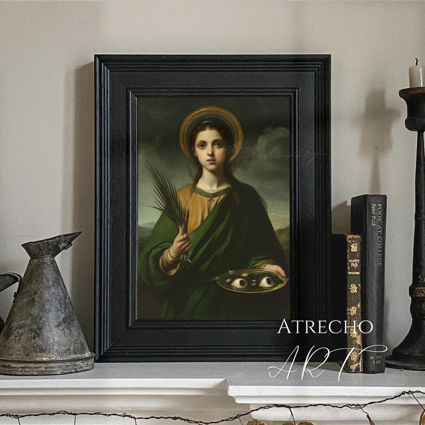 Saint Lucia art print in black frame on mantel — dark academia styled vignette with candle, antique books, and metal vessel, RE21 by Atrecho Art