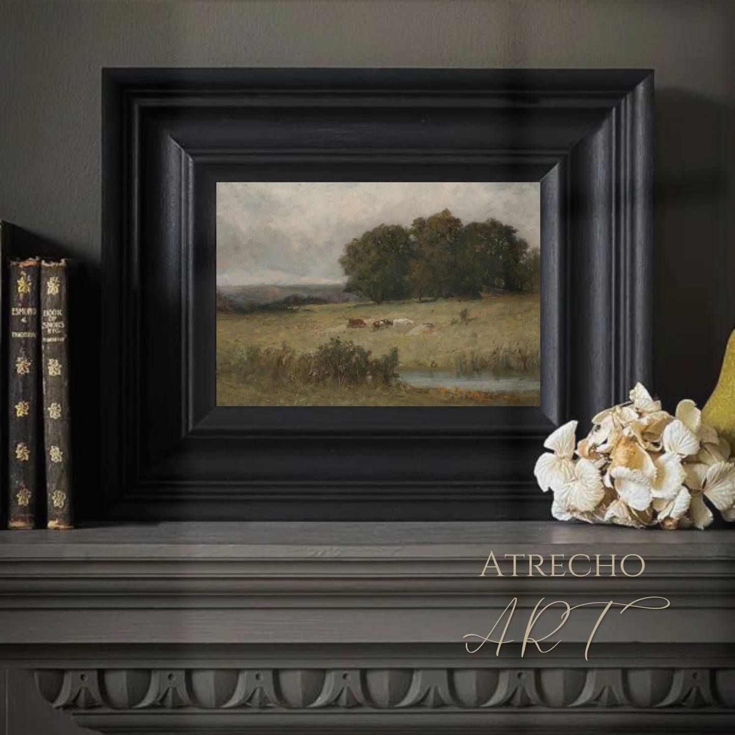Vintage landscape print in a warm study vignette with books and candles — Old Master pastoral scene, earthy tones