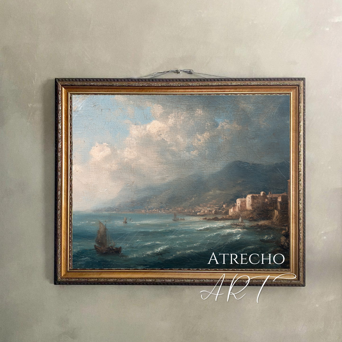Horizontal coastal town art print hung on a plaster wall with
a natural cord — Mediterranean harbor, Old World home decor